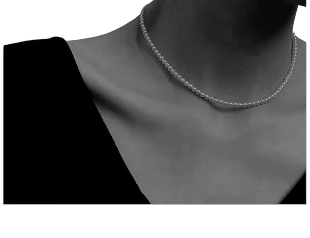 Freshwater pearl necklace choker with gold clasp on white background